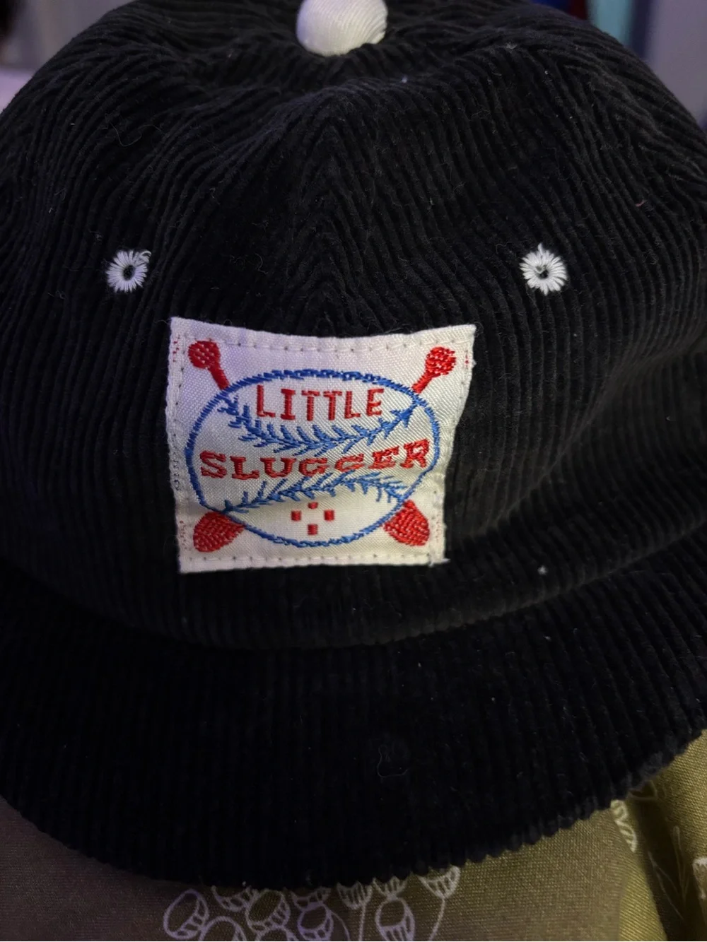 black corduroy baseball cap features a vintage-style 